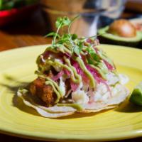 Dorado Fish Taco · Beer battered, avocado crema, pickled red onion, cabbage.