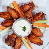 Buffalo Wings · Tossed in a mild or hot sauce. Served with celery sticks and blue cheese.