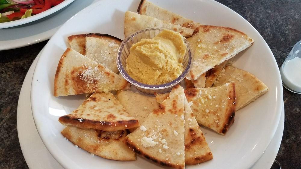 Pita Chips · Crisp baked pita triangles, virgin olive oil, and Parmesan cheese. Served with hummus.