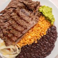 Carne Asada · Beef Mexican style served with rice, beans, guacamole, sautéed onions and tortillas.