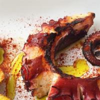 Pulpo A La Brasa · Grilled octopus with mashed potatoes in paprika sauce.