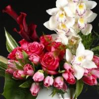 Scarlet · Contemporary flower arrangement featuring orchids, tulips, roses, and Callas.