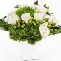Enchanted · A dozen of white roses nicely arranged in a white ceramic vase, with a touch of berries and ...