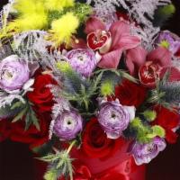 Scarlet Boheme · Luxurious red roses, thistle, purple ranunculus, orchids, lavender asparagus fern. Indulge y...