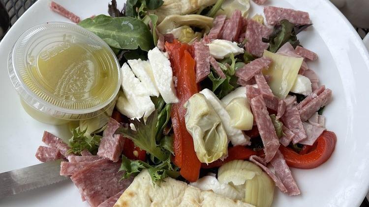 Antipasto · Mixed greens tossed with roasted peppers, artichokes, salami, provolone, fresh Mozzarella, red onions, and tomatoes in white balsamic vinaigrette.
