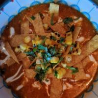 Tortilla Soup · Chicken, crispy tortilla strips, cilantro, onion, avocado, crema, in a chicken brodo