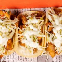 Crispy Fish Tacos · Tacos served with spicy slaw, and Jalapeno Tartar sauce