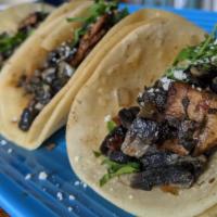 Huitlacoche And Hongos Tacos · A Delicacy of Huitlacoche and Mixed Mushrooms sauteed, topped with Cotija, Cilantro, Onion.