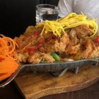 Mango Chicken · Crispy chicken tenders with steamed vegetables, topped with mango and chili sauce.