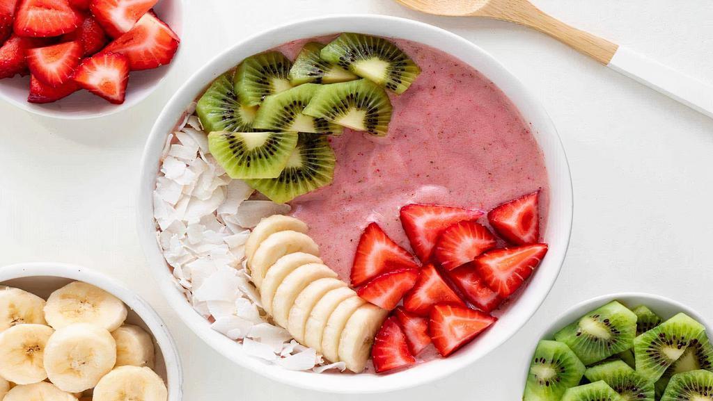 Tropical Acai Bowl · Acai berry blended thick with vanilla almond milk, mixed berries, banana, pineapple, topped with kiwi, pineapple, coconut and granola.