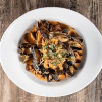 Steamed Mussels · Chorizo, fennel, pernod, and tomato cream sauce.