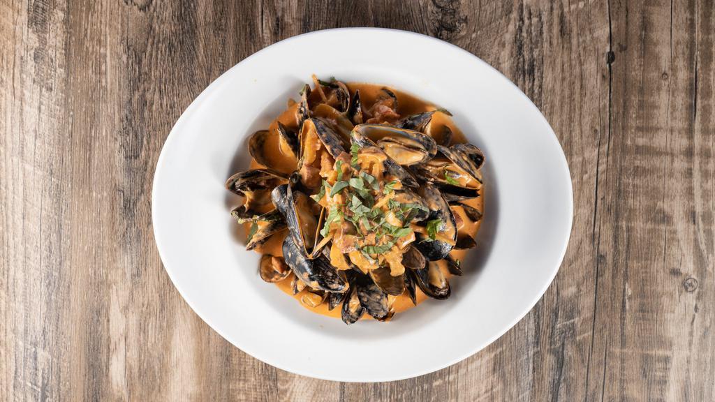 Steamed Mussels · Chorizo, fennel, pernod, and tomato cream sauce.