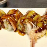 Ocean Roll · A cooked roll with shrimp tempura ,mango inside topped with crabstick, mango sauce and eel s...