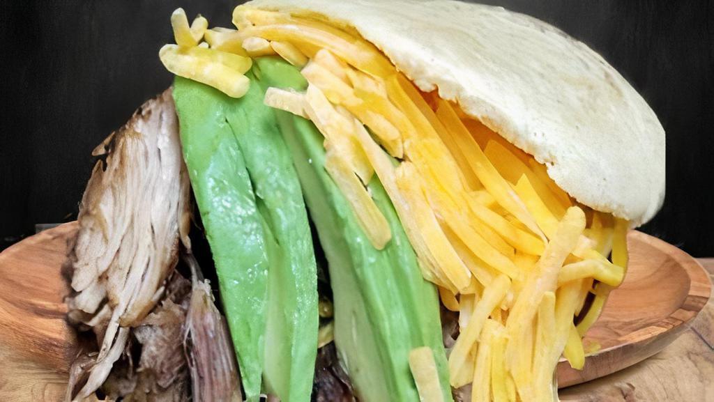 Arepa La Rumbera · The Rumbera Arepa - Is the arepa stuffed with the ingredients of the national dish of Venezuela, the 'Pabellon Criollo'. Frayed or shredded beef, avocado, black beans, fried sweet plantain slices and do not miss the grated cheese. Simply EXPLOITED!