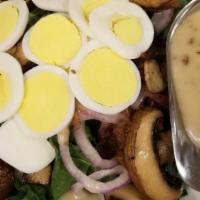 Spinach · Fresh baby spinach, red onions, bacon, crimini mushrooms hard boiled egg, served with a warm...