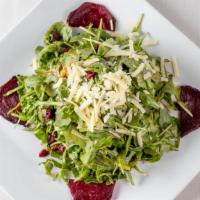 Baby Arugula Salad · With roasted beets, candied walnuts, cranberries, raspberry vinaigrette, and shaved parmesan...