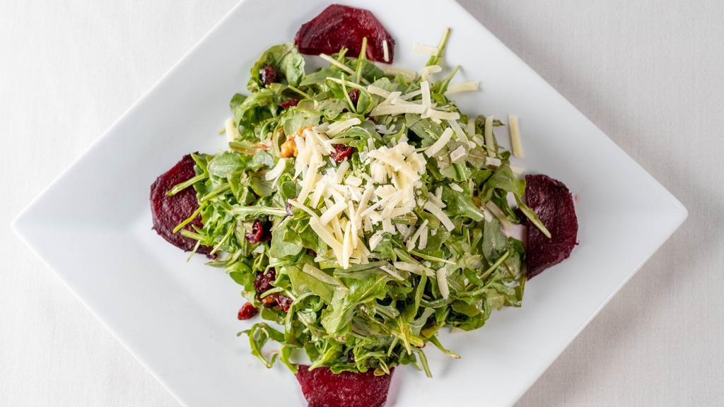 Baby Arugula Salad · With roasted beets, candied walnuts, cranberries, raspberry vinaigrette, and shaved parmesan cheese.