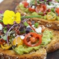 Avocado Toast · Multigrain bread topped with avocado spread, fresh cherry tomatoes, feta cheese, olive oil