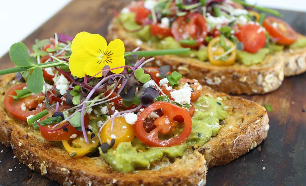 Avocado Toast · Multigrain bread topped with avocado spread, fresh cherry tomatoes, feta cheese, olive oil