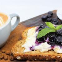Ricotta & Jam Toast · Multigrain bread topped with fresh ricotta, sea salt and choice of blueberry or strawberry jam