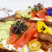 Salmon Toast · Multigrain bread topped with homemade labneh cream cheese, cucumber, fresh cherry tomatoes, ...