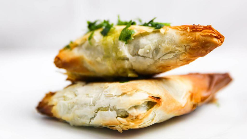 Spanakopita · Spinach Pie with fresh Spinach, leeks and feta cheese artfully wrapped in phyllo dough.
