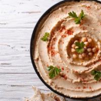 Hummus · Chickpea spread that is blended with tahini, olive oil, lemon juice and garlic. Served with ...