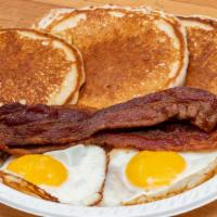 Pancakes, 2 Eggs, Bacon, Ham Or Sausage · Includes Coffee or Orange Juice