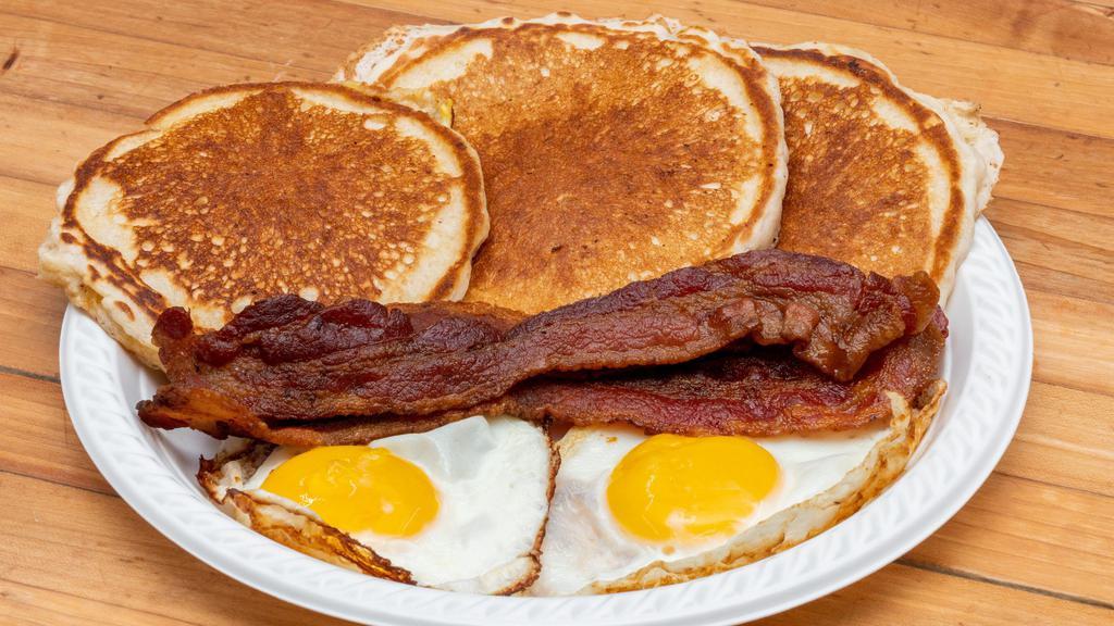 Pancakes, 2 Eggs, Bacon, Ham Or Sausage · Includes Coffee or Orange Juice