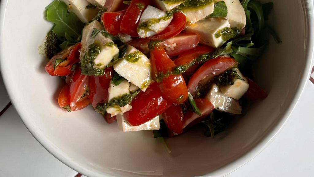 Caprese Salad · Bufala mozzarella, cherry tomatoes, basil pesto, homemade bread