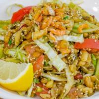 1) Tea Leaf Salad (Laphet Thoke) · Fermented tea leaves mixed with crunchy soy nuts & peanuts, sesame, dried shrimp, green & re...