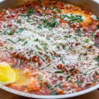 Classic Shakshuka · Sautéed tomatoes, green and red peppers served with two poached eggs.