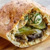 Falafel Sandwich · Vegan. Freshly baked pita bread with hummus, falafel, 
salad and tahini.