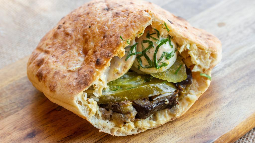 Falafel Sandwich · Vegan. Freshly baked pita bread with hummus, falafel, 
salad and tahini.