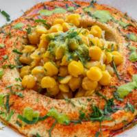 Masabacha · Vegan, gluten free. Freshly made hummus topped with whole chickpeas, olive oil, and paprika.