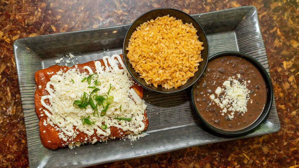 Enchiladas Plate · Three corn tortillas stuffed with rolled in enchilada sauce, topped off with Mexican sour cream, black olives, and queso fresco. Comes with rice and beans.
