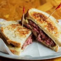 The Patty Melt · 5 oz all natural beef, buttered rye bread, Swiss cheese, stout caramelized grilled onions.