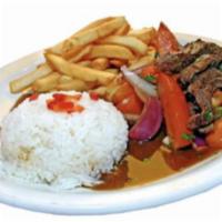 Lomo Saltado · Strips of beef sauteed with onions, tomatoes, soy sauce served over french fries and white r...