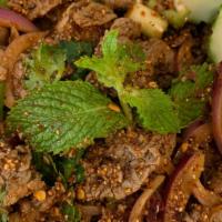 Nua Nam Tok · Sliced beef mixed with red onion, lemongrass, lime, chili powder, rice powder, cilantro, and...