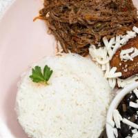 Pabellon Criollo · Shredded beef, black beans, fried sweet plantains, white cheese.