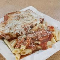 Chicken Cutlet Parmigiana · Breaded Chicken Cutlet Topped with Sauce & Melted Mozzarella served with a side of pasta.