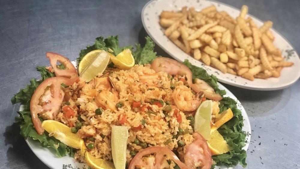 Arroz Con Camarones · Rice with shrimp, French fries and salad.