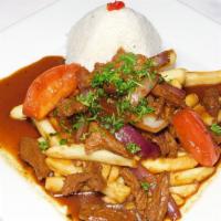 Lomo Saltado · Wok-seared steak, mixed with red onions, tomatoes, in soy sauce, served with fries and rice.