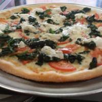 Margherita White Pizza · Spinach, fresh tomatoes, garlic and ricotta cheese.