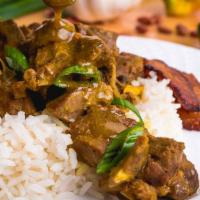 Curry Goat · Meals are served with a side of steamed vegetables, fried plantains, a choice of plain rice ...