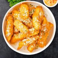Go Go Garlic Parmesan Tenders · Chicken tenders breaded, fried until golden brown before being tossed in garlic parmesan sau...