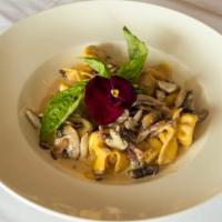 Fioretti Boscaiola · Pasta purses stuffed with four cheese, mushrooms, Pancetta and a touch of cream finished wit...