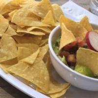 Chips And Guacamole · Corn chips with guacamole on top of chips.
