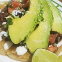 Sopes (1) · Corn base dough, refried beans, lettuce, sour cream, pico de gallo, avocado, and Cotija chee...