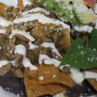 Chilaquiles Verdes · Crispy corn tortilla chips, covered in green tomatillo sauce, red onions, avocado slice, sou...